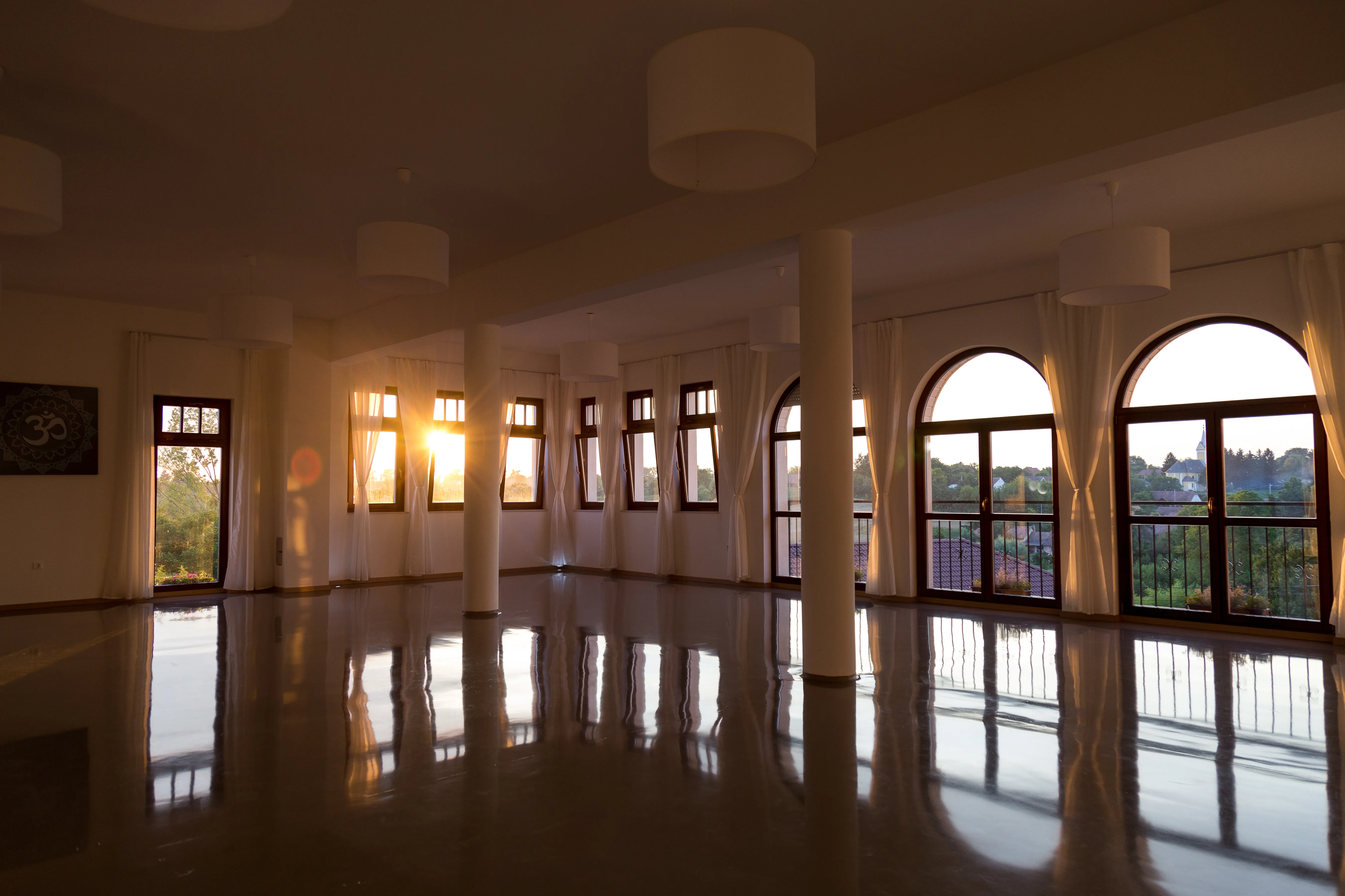 Bright yoga hall bathed in sunset light